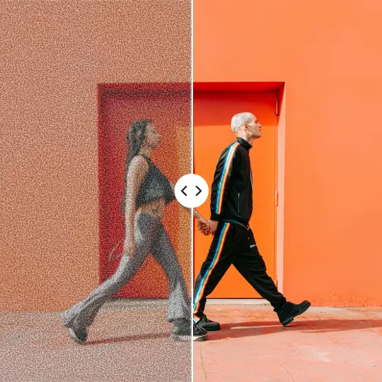 Blurry shot of two people walking becomes crisp and vivid near orange wall