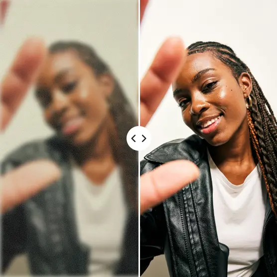 Smiling woman’s face enhanced from blurred view behind hand