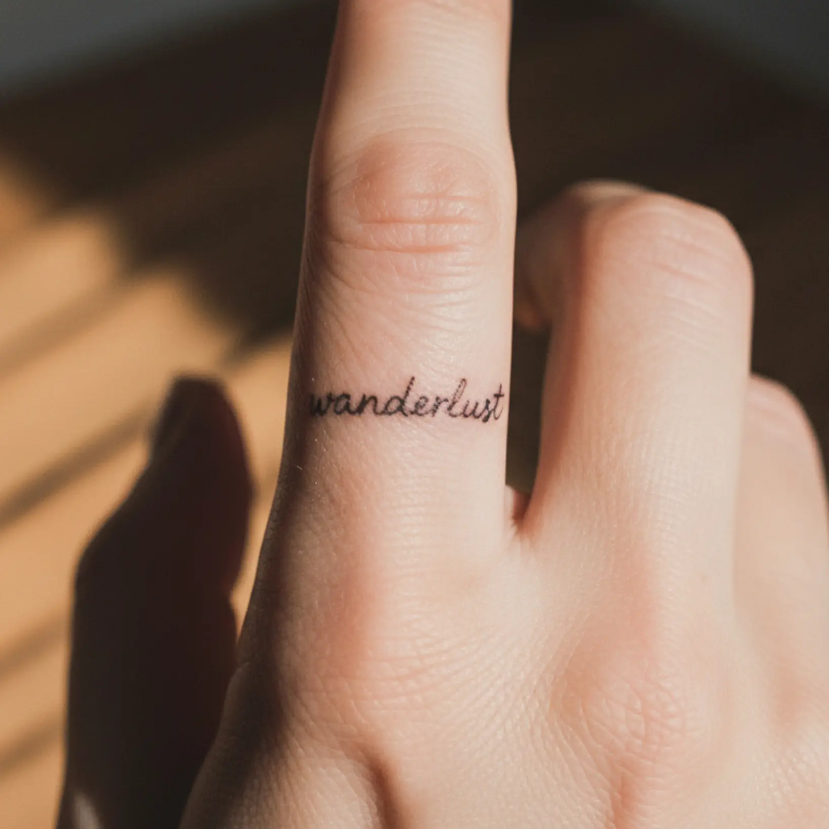 Tattoo font generator showing custom script design previewed on hand