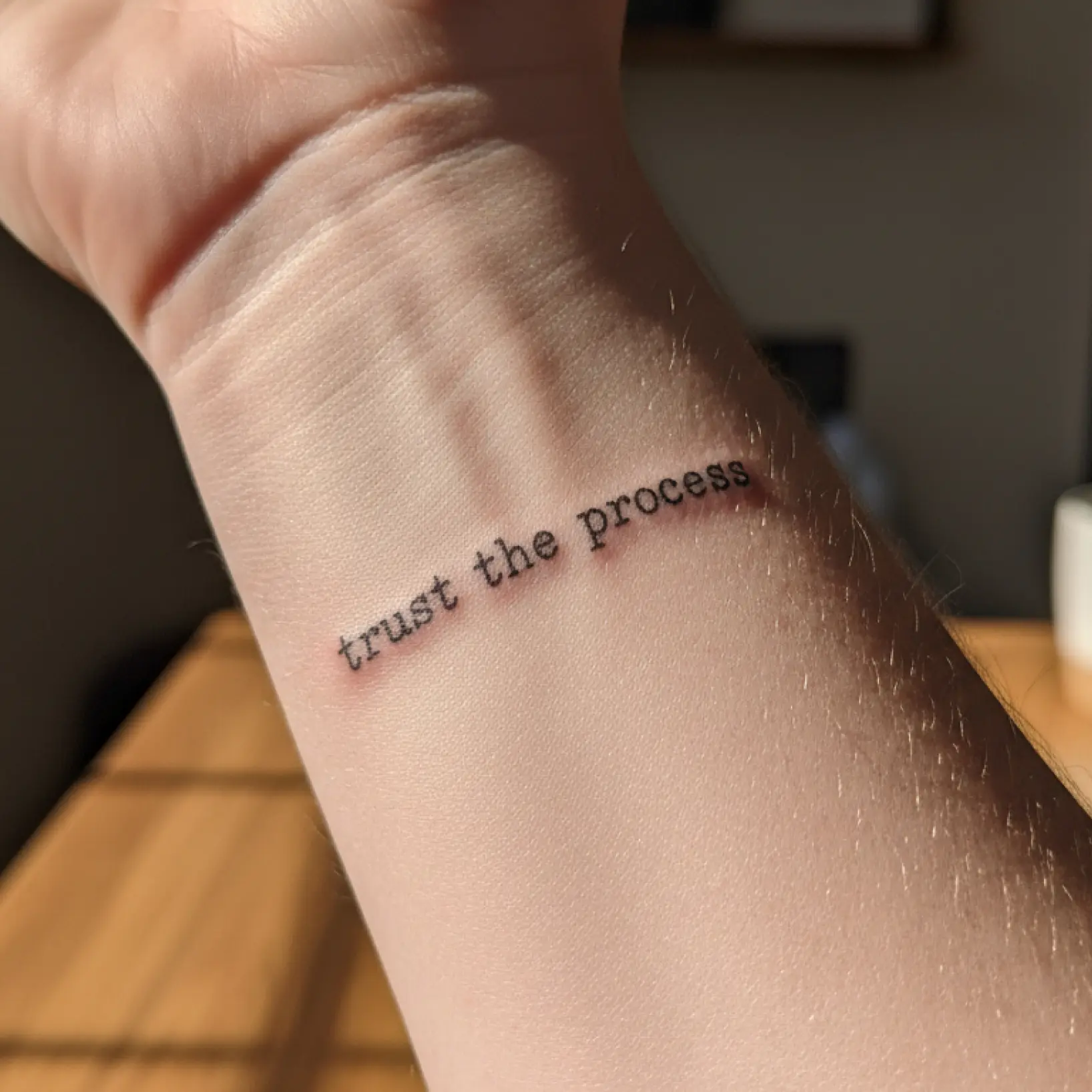 Tattoo font generator showing custom script design previewed on wrist